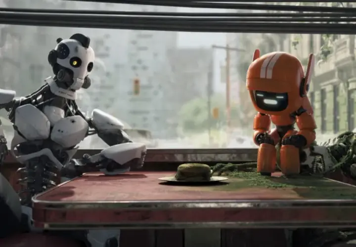 Dwa roboty siedzą przy stole w zniszczonym mieście. Jeden, duży i biały, wygląda na zamyślonego. Drugi, mały i pomarańczowy, patrzy na burgera. To scena z "Miłość, śmierć i roboty".