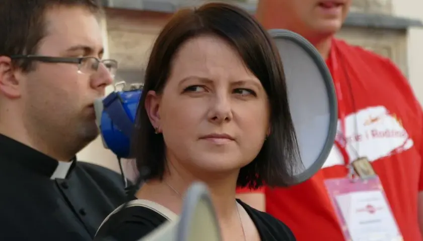 Kaja Godek z dziećmi na proteście. Kobieta z megafonem, obok ksiądz i mężczyzna w czerwonej koszulce.