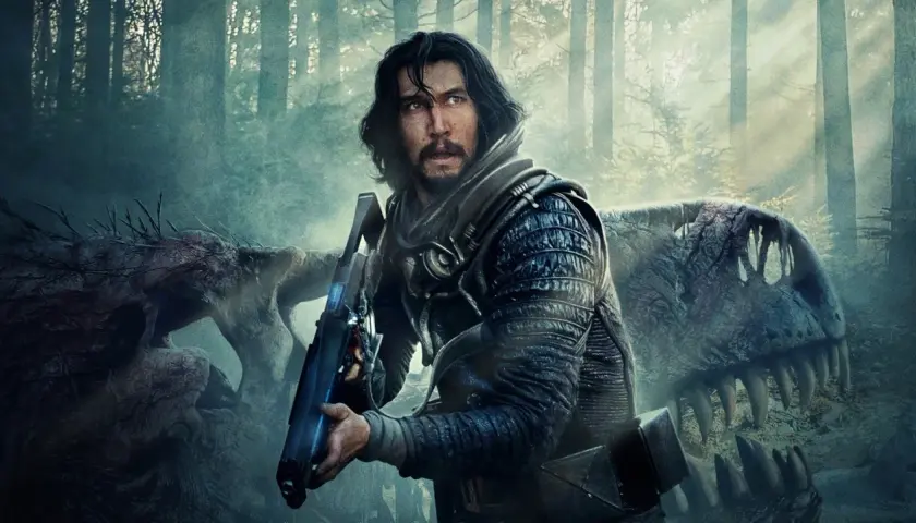 Adam Driver w futurystycznym stroju z bronią, obok szkieletu dinozaura. Scena z jednego z jego filmów.