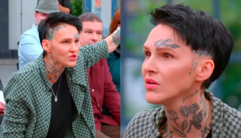 Agnieszka Chylińska z tatuażami na twarzy i szyi, w kratkowanej marynarce, mówi do ludzi. W tle widać inne osoby.