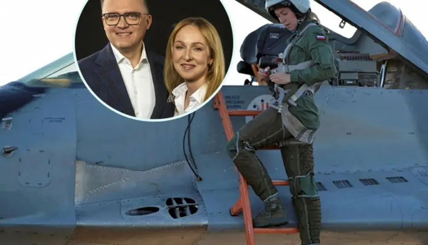 Szymon Hołownia i Urszula Brzezińska-Hołownia na tle myśliwca. Pilotka w kombinezonie i kasku wchodzi po drabinie do kokpitu.